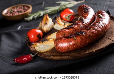 Grilled sausages with spices on black background. - Shutterstock ID 1593028393