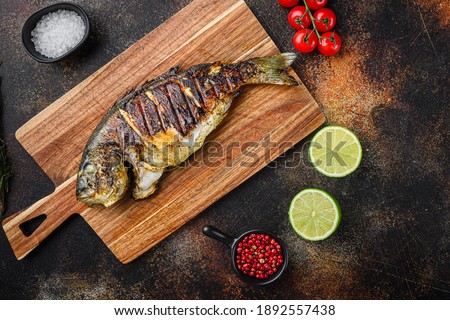 Similar – fresh whole sea bass fish on a black board