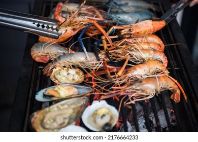 Grilled And Sea Shrimps, Mussel, And Scallop With Butter On Grill Pan. Seafood Barbecue Or Bbq For Family Party At Night