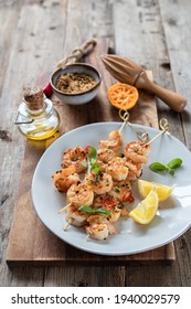 Grilled Shrimp Skewers With Garlic - Lemon Marinade And Baby Basil Leaves