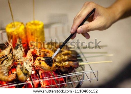 Grilled shrimp,prawn seafood on barbecue stove with chilly sauce and corn BBQ style mixed spicy .