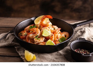 Grilled shrimps with greens and garlic in a pan