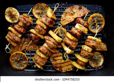 Grilled Skewers With Pineapple  And Chicken Meat  With Herbs On A Grill Plate. Fruit And Meat Skewers, Top View