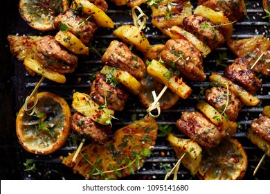 Grilled Skewers With Pineapple  And Chicken Meat  With Herbs On A Grill Plate. Fruit And Meat Skewers, Bbq, Top View.