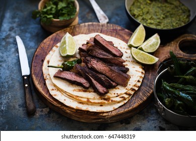 Grilled Skirt Steak Fajitas Recipe. Beef Steak Fajitas Tacos Hot Tortillas With Avocado Salsa And Green Peppers.