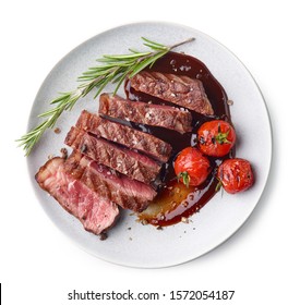 Grilled sliced Beef Steak with tomatoes and rosemary on a plate Isolated on white background top view - Shutterstock ID 1572054187