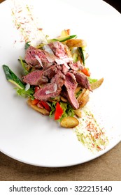 Grilled Sliced Roast Beef On Potato And Salad