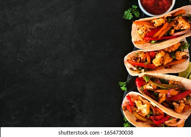 Grilled Spicy Cauliflower Fajitas. Overhead View Side Border With A Black Stone Background. Healthy Eating, Plant-based Meat Substitute Concept.