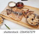 Grilled squid and peanuts on a cutting board, snacks