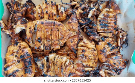 
Grilled squid, a seafood recipe in the form of squid grilled on top until cooked, with soy sauce and special spices. - Shutterstock ID 2357655425