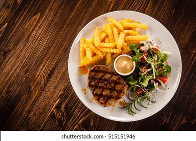 Grilled steak, French fries and vegetables - Powered by Shutterstock