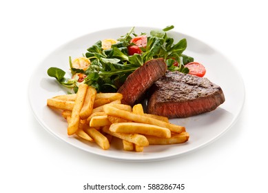 Grilled steak, French fries and vegetables  - Powered by Shutterstock