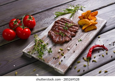 Grilled Steak With Fried Potatoes And Tomatoes. Exclusive Dish.