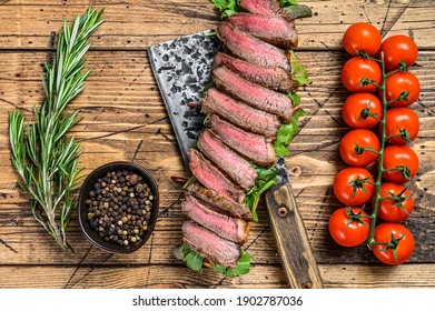 Grilled Steak Sandwich With Arugula And Cheese On A Meat Ceaver. Wooden Background. Top View.