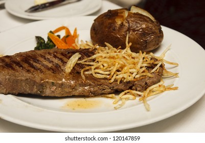 Grilled Strip Steak With Fried Onion Strings And Baked Potato