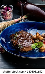 Grilled Striploin Angus Steak Cut In Pieces Decorated. Sliced Steak Top View. Copy Space On A Blue Plate