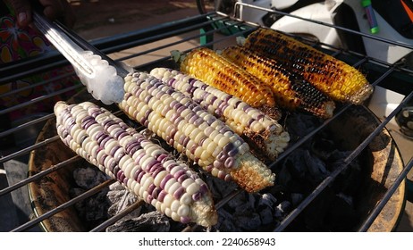 Grilled sweet corns and waxy corns on the grill, easy and nutritious snack in Thailand. - Shutterstock ID 2240658943