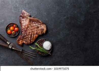 Grilled T-bone Steak On Stone Table. Top View With Copy Space