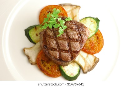 Grilled Thick Filet Mignon Served With King Oyster And Tomatos