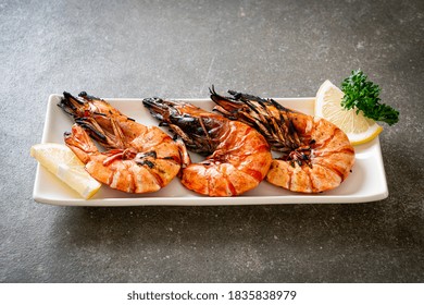 Grilled Tiger Prawns Or Shrimps With Lemon On Plate