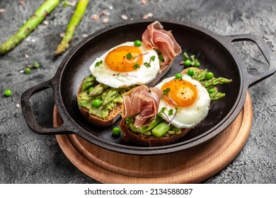Grilled Toast witch Asparagus, Poached egg, bacon jamon, ham, banner, menu, recipe place for text, top view Food recipe background. Close up,