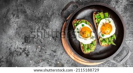 Grilled Toast witch Asparagus, Poached egg, bacon jamon, ham, banner, menu, recipe place for text, top view Food recipe background. Close up,