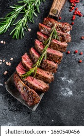 Grilled top blade, Denver steak. Marble meat beef. Black background. Top view