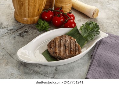 Grilled tuna medallion in the plate with spices