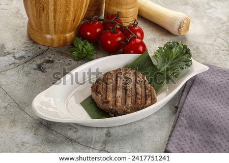 Grilled tuna medallion in the plate with spices