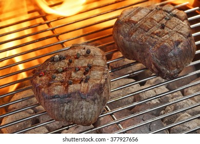 Grilled Two Beef Fillet Medallions On The Flaming Barbecue Grill, Outdoor Scene, Top View, Close Up. Backyard Party Or Picnic Concept.