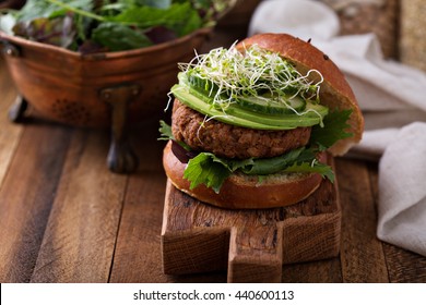 Grilled Vegan Bean Burger With Avocado, Salad And Cucumber