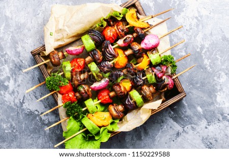Grilled vegetable kebabs on skewers with tomato, pepper, mushrooms,zucchini and onion.Diet barbecue.Vegan skewers