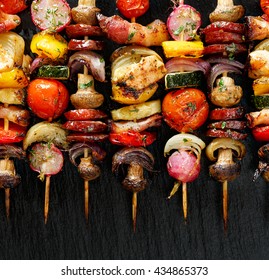 Grilled Vegetable And Meat Skewers  On The Black Stone Background, Top View