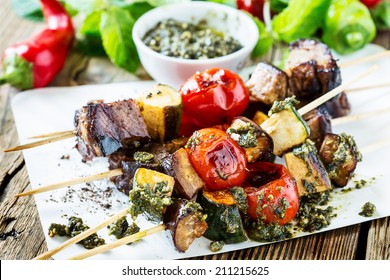 Grilled  Vegetables And Beef Shish Kabobs On Skewers With Pesto Sauce On Wooden Rustic Table