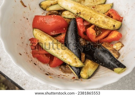 Grilled vegetables -bell peppers, zucchini, eggplant on a white plate, top view, close-up