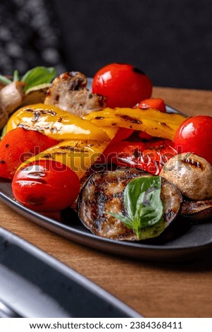 Grilled vegetables, colorful bell pepper, zucchini, eggplant, cherry tomatoes. Delicious. Dish serving in a restaurant, menu food concept.