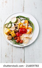 Grilled Vegetables On The White Plate On Blue Textured Background