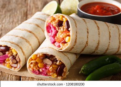 Grilled Veggie Burrito With Rice, Beans, Corn, Tomatoes, Peppers And Cabbage Close-up On The Table. Horizontal
