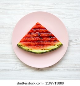 Grilled Watermelon On A Pink Plate Over White Wooden Background, Overhead View. Healthy Summer Fruit. Flat Lay, Top View.