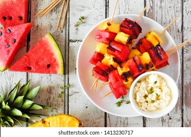 Grilled Watermelon And Pineapple Fruit Kabobs With Feta. Top View On A White Wood Background. Summer Food Concept.