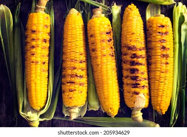 Grilled Young Corn From Above On The Wooden Table 