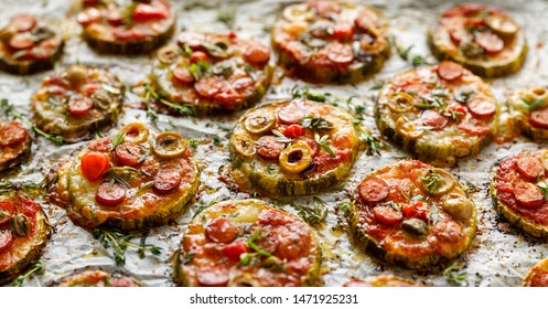 Grilled Zucchini Slices With Addition Of Mozzarella Cheese, Sausage, Green Olives, Capers And Herbs On White Baking Paper, Cloys-up. Delicious Appetizer, Zucchini Pizza Bites