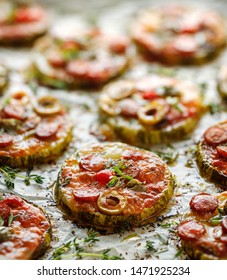 Grilled Zucchini Slices With Addition Of Mozzarella Cheese, Sausage, Green Olives, Capers And Herbs On White Baking Paper, Close-up. Delicious Appetizer, Zucchini Pizza Bites