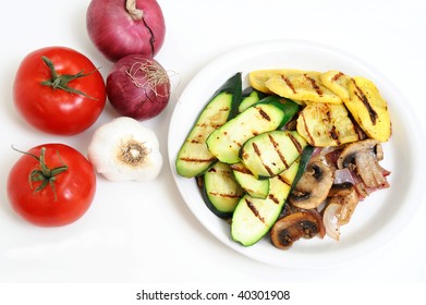 Grilled Zucchini And Yellow Summer Squash On A White Plate With Tomatoes, Onions And Garlic