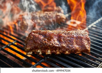 Grilling Baby Back Pork Ribs Over Flaming Grill