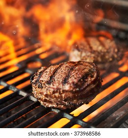 Grilling Filet Mignon Steaks On Grill With Flames Shot With Extreme Selective Focus