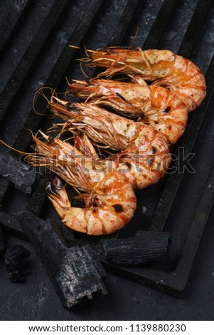 Grilling fresh shrimp on skewers.