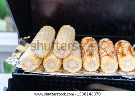 Grilling fresh summer vegetables on an outdoor gas grill.