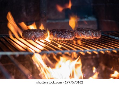 Grilling homemade  burgers on open fire 