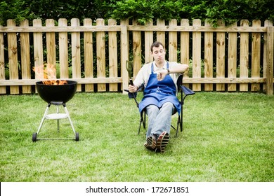 Grilling: Man Waits For Charcoal To Cook Down